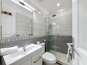 a bathroom with a toilet and a sink and a shower at Le Montgy - Studio tout confort à Royat National N1 in Royat