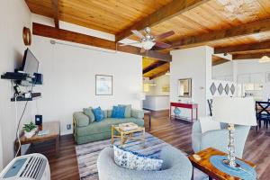 a living room with a couch and a ceiling fan at Rockaway Beach View in Port Blakely