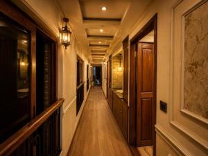 a hallway of a house with wooden floors and a light fixture at Kerala Boat Trips in Kumarakom
