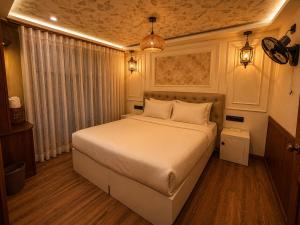 a bedroom with a large bed in a room at Kerala Boat Trips in Kumarakom