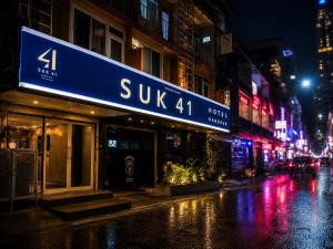 a building on a city street at night at Suk41 Bangkok Hotel in Bangkok