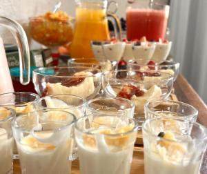 a group of glasses of desserts on a table at Pouso das Flores - Próximo a Maria Fumaça in Tiradentes