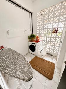 a white room with a bed and a window at The Teduh Homestay By Rumah Mimpi in Kertih