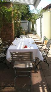 a table with a white table cloth on a patio at Design Hotel Zollamt in Kaiserslautern