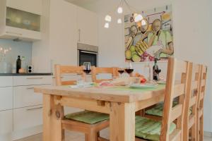a kitchen with a wooden table with glasses of wine at Residenza sul Lago Maggiore in Luino