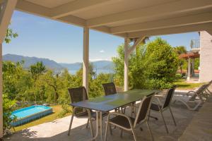 a patio with a table and chairs and a pool at Residenza sul Lago Maggiore in Luino +33 photos