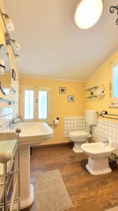 a bathroom with a tub and a toilet and a sink at Cappone B&B in Morciano di Romagna