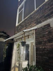 a window on a brick house with a potted plant at Casablanco Addis in Addis Ababa