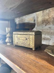 a metal box sitting on a wooden table at Бекяровата къща in Spasovtsi