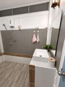 a bathroom with a white sink and a mirror at Thai house in Chaweng in Nathon Bay +21 photos