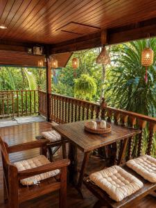 a wooden porch with a wooden table and benches at Thai house in Chaweng in Nathon Bay