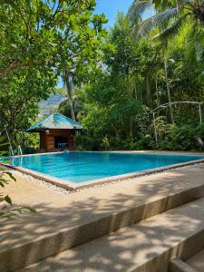 a swimming pool with a gazebo in a forest at Thai house in Chaweng in Nathon Bay