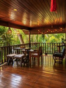 a porch with a table and chairs on a deck at Thai house in Chaweng in Nathon Bay
