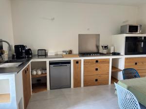 a kitchen with a sink and a stove top oven at Maison éla in Bessas
