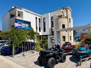 a group of atvs and motorcycles parked in front of a building at Blue Star Apartments in Ulcinj