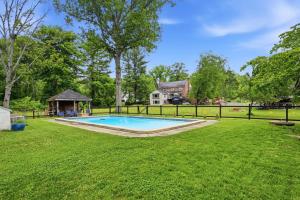 a backyard with a pool and a gazebo at 4 BR Suburban Escape - Pool, Tennis, Trails, Gym in Newtown Square