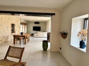 a living room and dining room with a table and chairs at Maison éla in Bessas