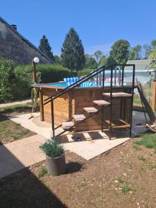 a playground with a slide and a slidesktop at Chambres d'hôtes chez Peggy et Eric chambre indus in Équevillon
