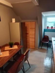 a kitchen with a table and chairs and a refrigerator at FördeFlats in Flensburg