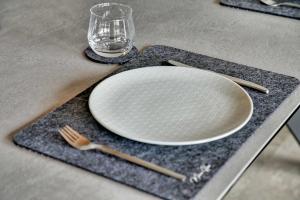 a plate and a fork and a glass on a table at Chalet Alba in Lichtenberg