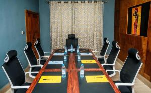 a conference room with a long table and chairs at Regal Hotel Douala in Douala