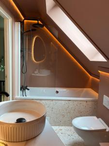 a bathroom with a large bath tub and a toilet at Lake House in Vossevangen