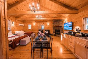 a living room with a bed and a table in a cabin at Sunset Chalet in Belgrade