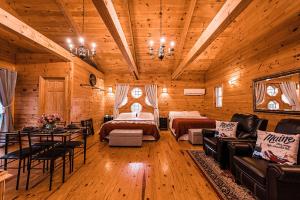 a log cabin with two beds and a living room at Sunset Chalet in Belgrade