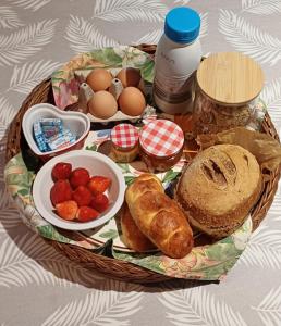 a basket of breakfast food with eggs bread and strawberries at L escapade de la voie douce in Le Cheylard