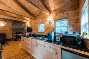 a kitchen with wooden cabinets and a stove top oven at Sunset Chalet in Belgrade