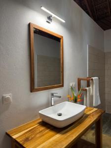 a bathroom with a white sink and a mirror at Mahé Lodge, Nosy Be in Nosy Be +40 photos