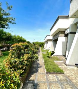 a brick walkway next to a white building at Hotel Abiron in Wanseko