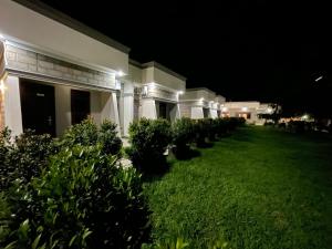 a yard of a house at night with bushes at Hotel Abiron in Wanseko