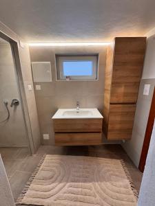 a bathroom with a sink and a window at Appartement Grande Dixence - Hérémence in Hérémence