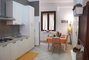 a kitchen with a table and a dining room at Casa Gaia Palermo in Palermo