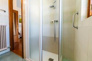 a shower with a glass door in a bathroom at Dimora Wilma in Peschiera del Garda