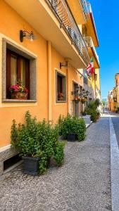 a building with potted plants on the side of a street at Hotel Terranova in Olbia