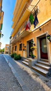a building with flags on the side of it at Hotel Terranova in Olbia