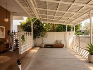 a patio with a cat standing in the middle of it at Aura Home Kalasin in Kalasin