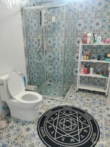 a bathroom with a shower and a toilet with a mandala rug at Aura Home Kalasin in Kalasin +62 photos