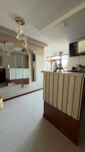 a large room with a kitchen with a counter at Hotel Residencial Paris in Arequipa +21 photos