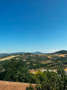 a view of a valley with trees and a blue sky at La Casetta Noble House in Casoli