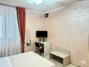 a room with a bed and a desk with a computer at Pasubio House appartamento in Campobasso