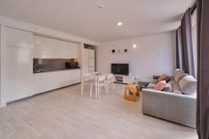 a living room with a couch and a table at Aeropuerto loft 8 by Azahar Stay in Manises +5 photos