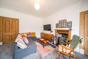 a living room with a couch and a fireplace at The Palais in Dundee
