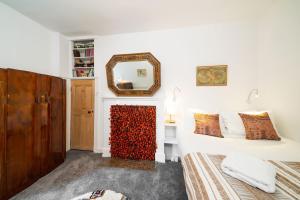 a bedroom with a bed and a mirror at The Palais in Dundee