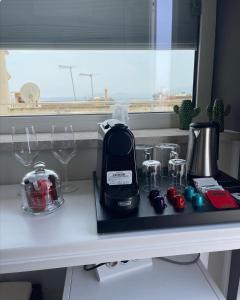 a kitchen counter with a toaster and wine glasses at 18 Dante Luxury Suites in Cagliari