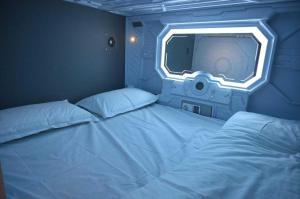 a bedroom with a large bed and a tv at Collection O Airport Road Formerly Hotel Nano Pod in Surat