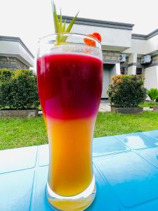 a glass with a drink on a table at Hotel Abiron in Wanseko