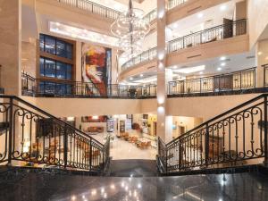 a large lobby with a staircase in a building at Rixos Borovoe in Borovoye